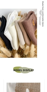 Close-up of knit cotton socks with yellow flower embroidery in various warm colors