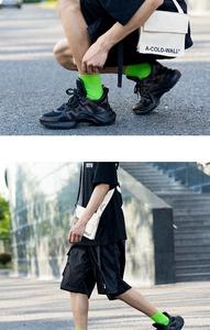 Detail of neon green cotton crew socks styled with chunky sneakers and urban streetwear
