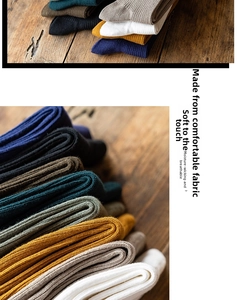 Close-up of ribbed cotton socks in various vintage colors on a rustic wooden background