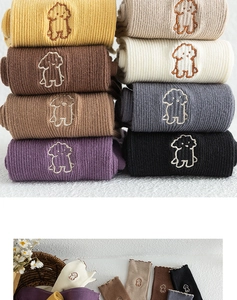 Detail of cotton crew socks showing delicate puppy embroidery and wavy ruffled edge
