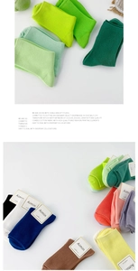 Close-up of ribbed combed cotton socks in various vibrant Morandi colors with brand tags