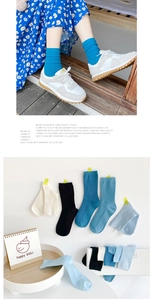 Close-up of ribbed cotton crew socks in blue and neutral tones for a stylish casual look