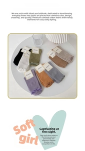 Close-up of ruffled lettuce edge cuffs on soft combed cotton crew socks in morandi colors