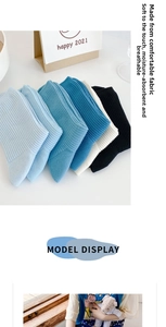 Detailed close-up of ribbed texture and elastic knit on blue cotton crew socks