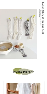 Detail of soft cotton kids socks featuring cherry and polka dot jacquard patterns