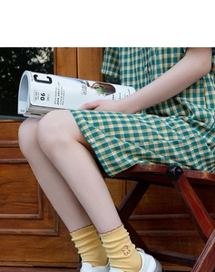 Detail of ginger yellow ribbed mid-tube socks with cute bear embroidery on the ankle