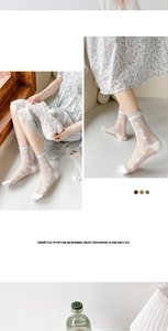 Detail of white mesh socks featuring blue daisy embroidery and elegant ruffle cuffs