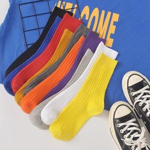 Colorful vertical ribbed crew socks for men and women in various solid knit cotton colors