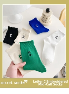 Detail of ribbed cotton mid-calf socks with premium C letter embroidery in vibrant colors