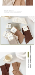 Detailed texture of combed cotton ribbed socks in various neutral earthy colors