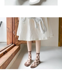 Detail of cute bear pattern sheer mesh socks with brown heel and toe accents on model