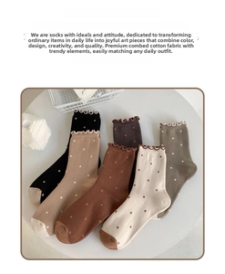 Detail of five pairs of warm cotton socks with vintage polka dots and ruffle edges