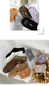 Close-up of Morandi colored cotton socks featuring delicate daisy embroidery detail