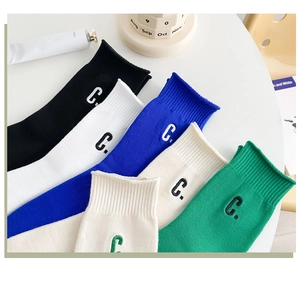Detail of five pairs of cotton socks with C-letter embroidery in varied colors