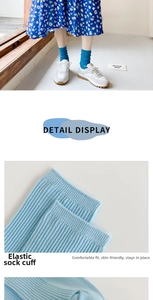 Detail view of sky blue vertical striped cotton socks with elastic wide cuff design