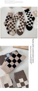 Detail of thickened checkerboard wool socks with warm fleece lining and retro colors