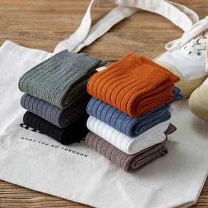 Men's cotton crew socks in 7 colors with ribbed texture on rustic wood background