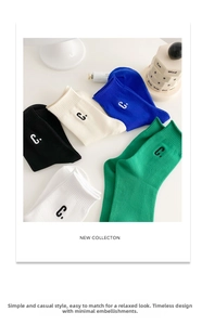 Close-up of five-color cotton socks featuring contrast 'C' letter embroidery detail