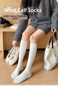 Detail of white wool socks featuring thick vertical rib knit texture for winter warmth
