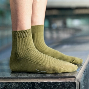 Olive green crew socks for men featuring vertical ribbing and side printed text