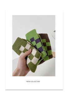 Detail shot of thick wool checkered socks in three vintage colorways for winter warmth