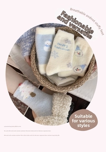 Detailed view of thick blue snowman thermal socks with soft winter fleece texture