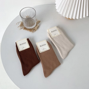 Three pairs of vintage waffle knit combed cotton crew socks in brown, khaki, and cream