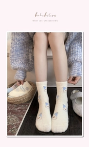 Close-up of thick winter fleece socks with cute blue snowman pattern and soft texture
