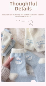 Detailed close-up of blue winter socks with snowman pattern and soft knit texture