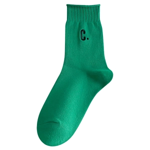 Bright green crew socks with C letter embroidery and ribbed knit texture for daily wear