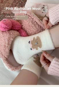 Close-up of pink fluffy thermal socks with cute brown puppy embroidery for women