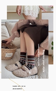 Close-up of thick winter wool socks with vintage floral snowflake and stripe patterns
