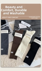 Detail of wool socks set in grey, brown, white, black with soft fuzzy texture