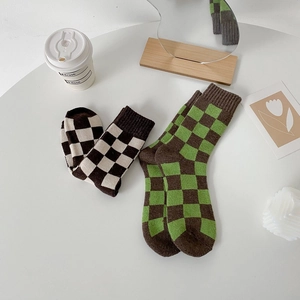 Thick checkered wool mid-calf socks in retro brown, green, and beige vintage style