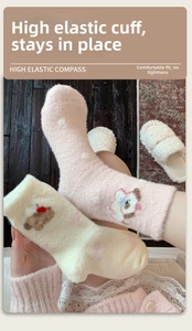 Close-up of pink thermal socks with cartoon dog patterns and thick coral fleece texture