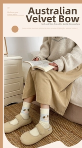 Cozy cream socks with blue stripes and brown puppy pattern worn in a home setting