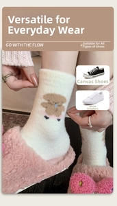 Detail of warm off-white winter socks with cute brown bear pattern and plush texture