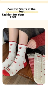 Detail of white cotton crew socks featuring red cat embroidery and floral scallop trim