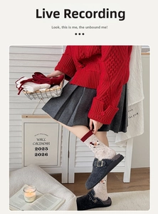 Detailed knit texture of wool socks featuring cute cartoon patterns and red ribbed cuffs