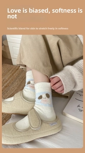 Close-up of thick thermal winter socks featuring cute cartoon dog pattern and soft texture
