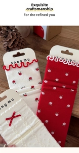 Detailed view of three cute cotton socks with floral patterns, bows, and lace edges