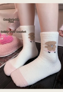 Close-up of thick pink puppy thermal socks with soft fuzzy texture and cute bear embroidery