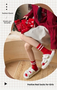 Detail of red festive cotton socks featuring cute puppy embroidery and plush textures
