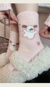 Detailed view of thick pink plush socks with cartoon dog design and soft elastic texture