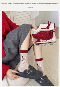 Detail of warm wool socks with cute puppy patch and contrasting red-white ribbing cuff