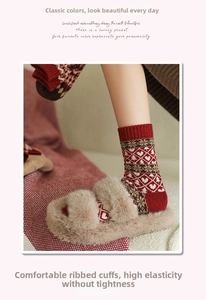 Close-up of red Fair Isle socks with heart patterns and warm winter knit textures