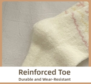 Close-up of reinforced toe detail on thick fuzzy socks with pink and yellow wavy stripes