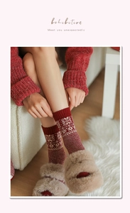 Close-up of winter wool socks featuring white snowflake and Fair Isle knitting patterns