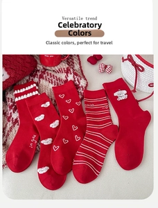 Detailed set of five red festive socks with cute puppy embroidery and heart patterns