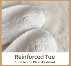 Detailed close-up of reinforced toe stitching on white wool knit socks for durability